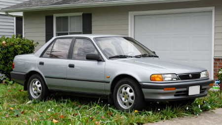 car parked in grass on side of house generated with Z-Image