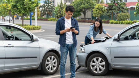 man texting between crashed cars woman inspecting damage generated with Z-Image