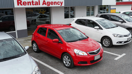 red compact car in rental agency parking lot generated with Z-Image
