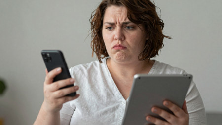 woman holding a phone in one hand and tablet in the other generated with Z-Image